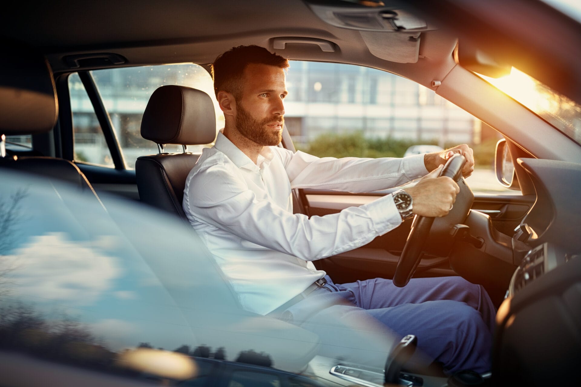 Young businessman driving car